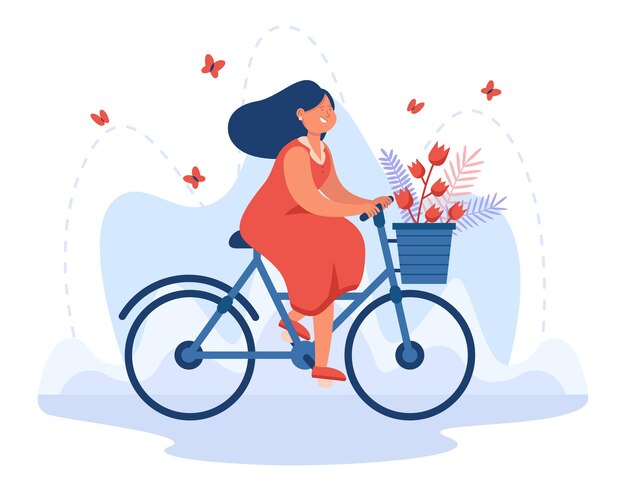 Happy young girl riding bicycle with bouquet in basket