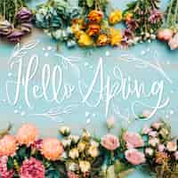 Free vector hello spring lettering with realistic flowers