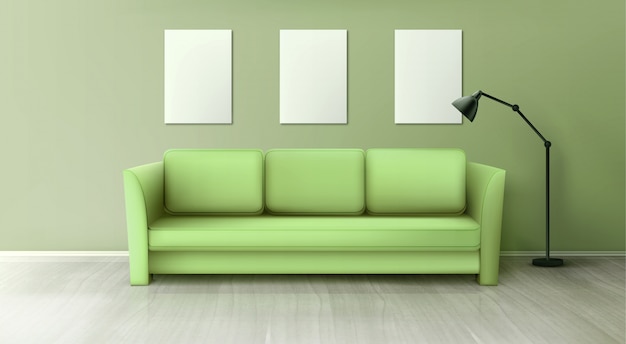 Интерьер с зеленым диваном, лампой и белыми постерами