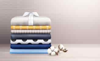 Free vector ironed clothes and colorful linen stack decorated with cotton branch realistic composition