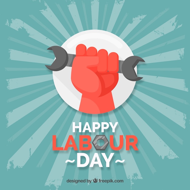 Free vector labour day background with hand holding toolin flat style