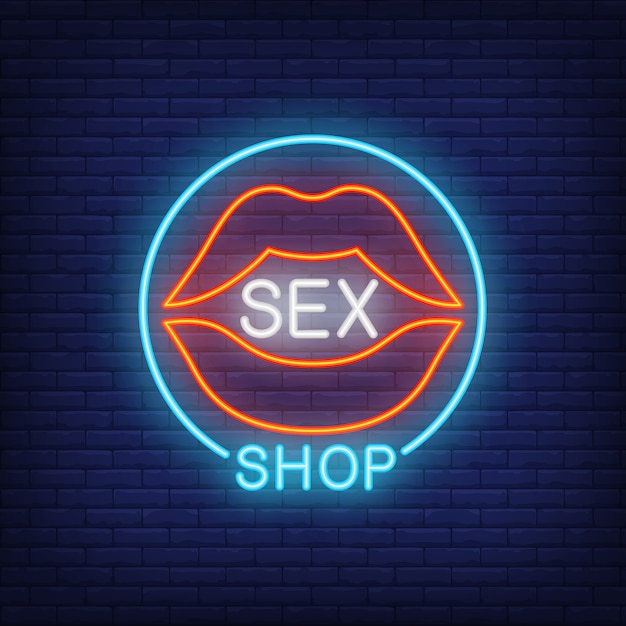 Labbra con scritte su sex shop in cerchio. insegna al neon sul fondo del mattone.