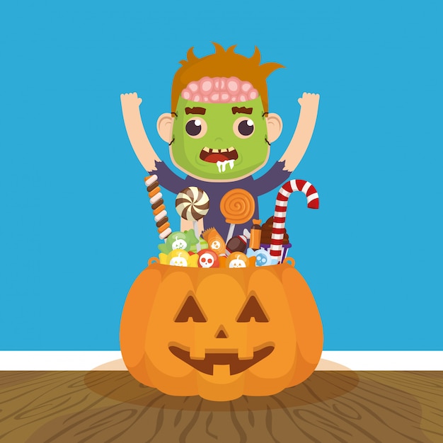 Little boy with zombie disguise and candies pumpkin