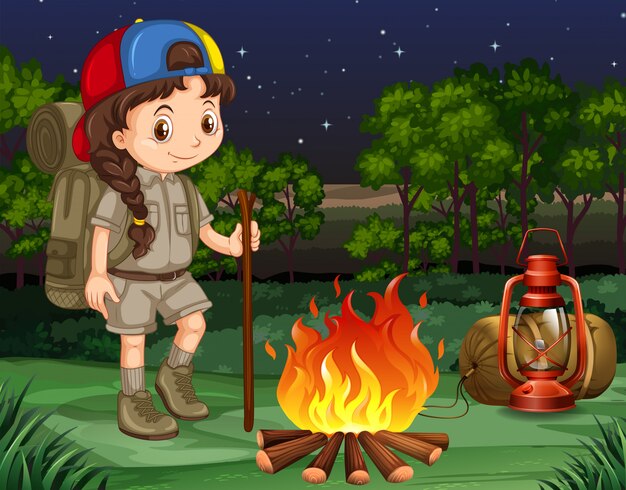 Little girl standing by the campfire