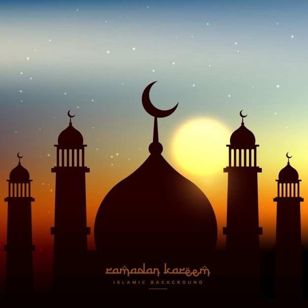 Mosque silhouette in evening sky with sun