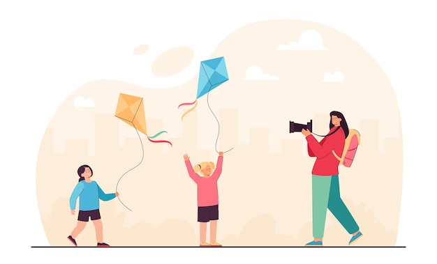 Mother taking picture of daughters playing game with kites. woman holding photo camera flat vector illustration. summer adventure, vacation concept for banner, website design or landing web page