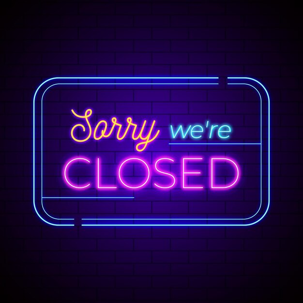 Neon 'sorry we are closed' sign on brick wall