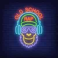 Free vector old school rap neon text and cool monkey in glasses and headphones.