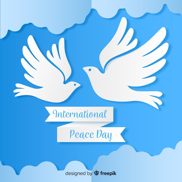 Free vector paper peace day with dove and clouds