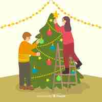 無料ベクター 屋内でクリスマスツリーを飾る人々