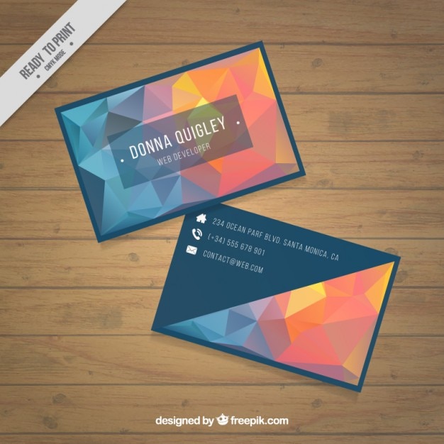 Free vector polygonal business card in blue and orange tones