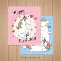 Free vector pretty birthday cards with hand drawn unicorn