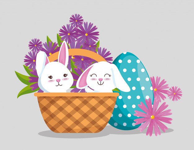 Rabbits inside basket with egg decoration and flowers