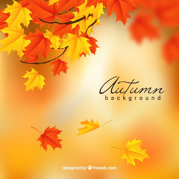 Realistic autumn background with blurred leaves