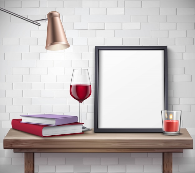 Free vector realistic frame template on the table with glass of wine candle lamp and books