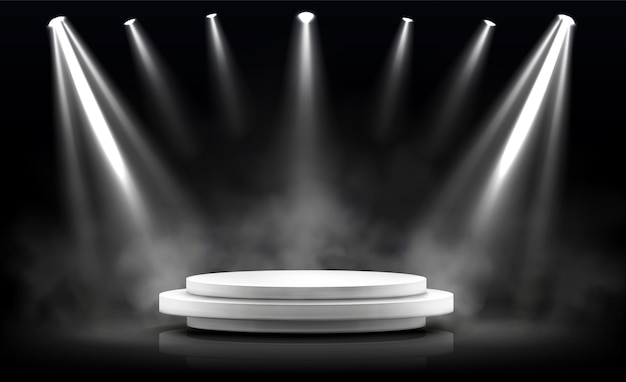 Round podium, empty stage illuminated by spotlights.