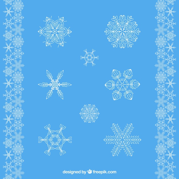 Vettore gratuito selezione di fiocchi di neve decorativi con sfondo blu