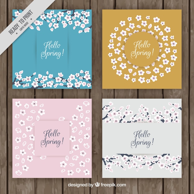 Free vector set of four spring greeting cards with hand-drawn flowers