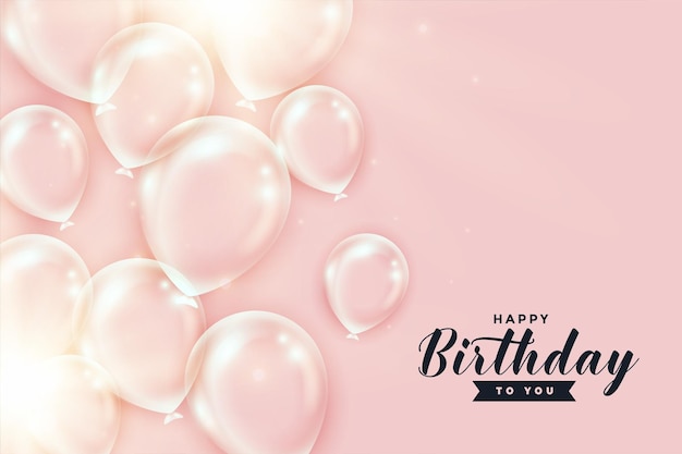 Shiny transparent birthday balloons on peach color background