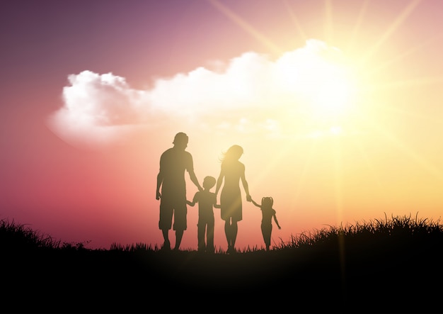Silhouette of a family walking against a sunset sky