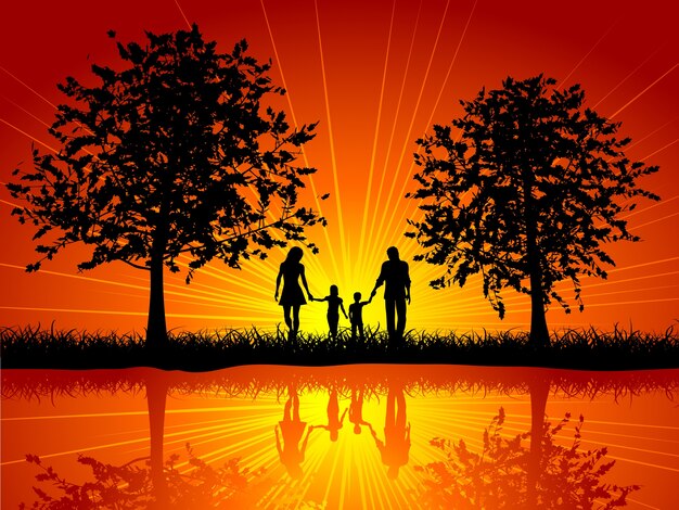 木の下で歩く家族のシルエット