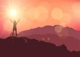 Free vector silhouette of a female stood on top of a mountain against a sunset sky
