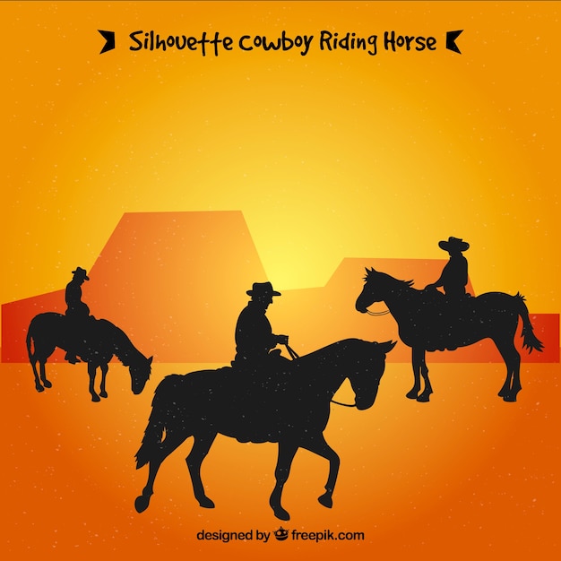 Silhouette of three cowboys riding