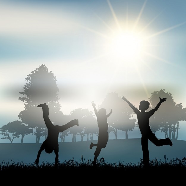 Silhouettes of children playing in the countryside