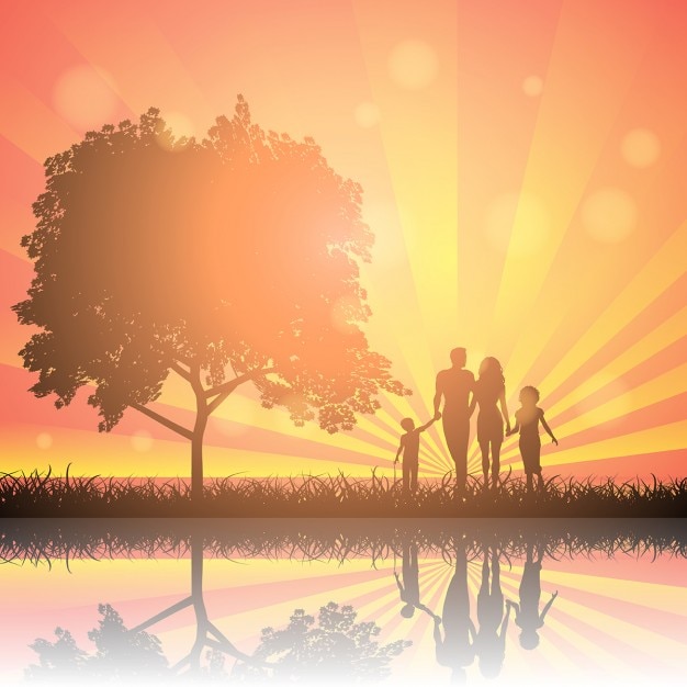 Silhouettes of a family walking in the countryside