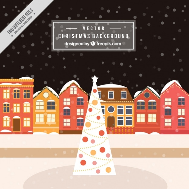 Free vector snowy houses background with christmas tree