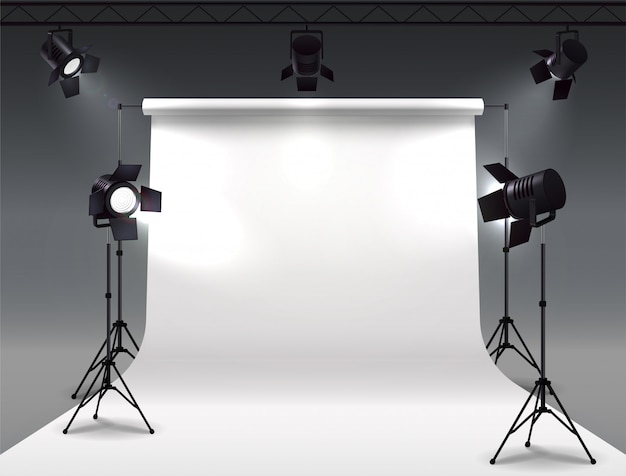 Free vector spotlights realistic composition with cyclorama and studio spot lights hanging on reel and mounted on stands