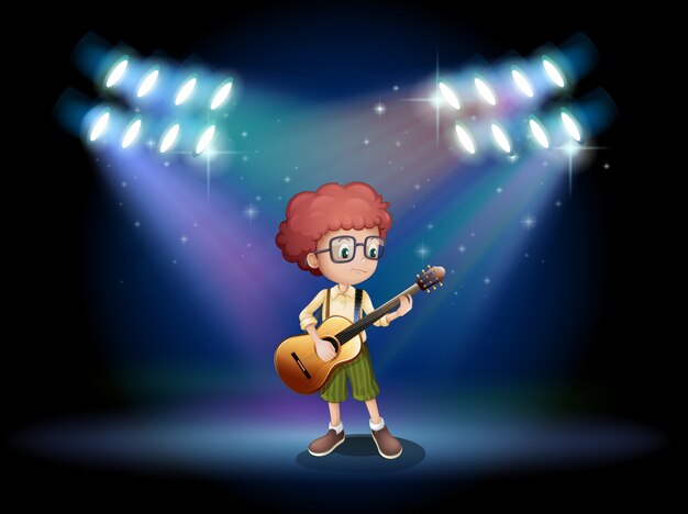 ステージの真ん中でギターを弾く才能のあるティーンエイジャー