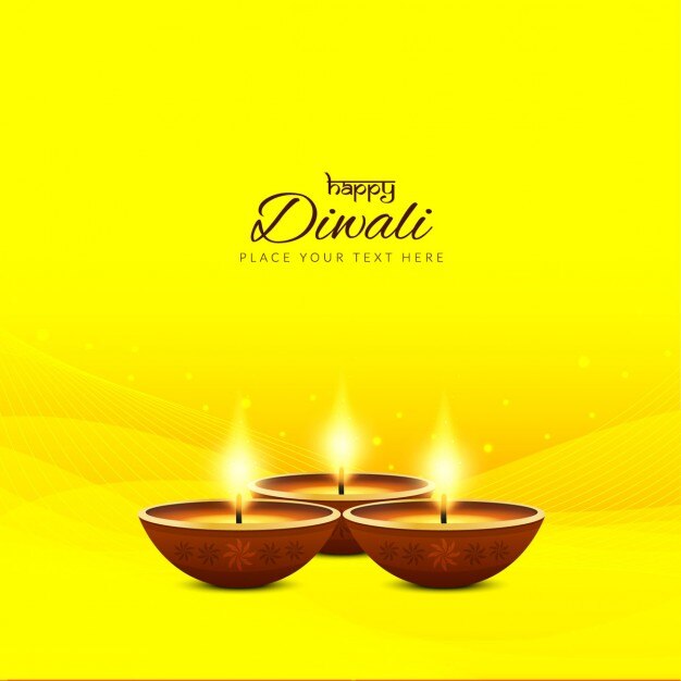 three candles for diwali on a bright yellow background