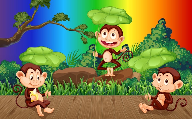 Tre scimmie nella foresta su sfondo arcobaleno sfumato