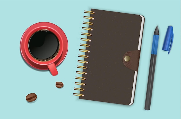 テキストやモックアップを追加する準備ができてコーヒーのカップの横にあるノートブックを閉じた上面図