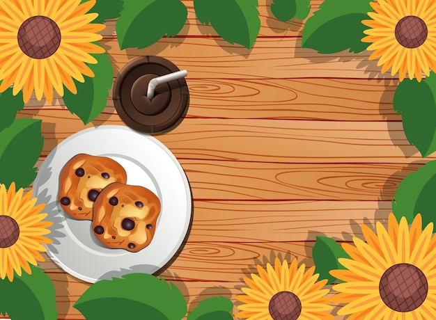 Top view of wooden table with dessert and iced coffee and leaves and sunflower element