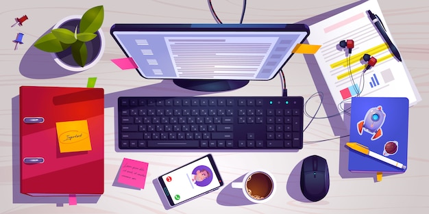 Top view of workspace with computer, stationery, coffee cup and\
plant on wooden table.