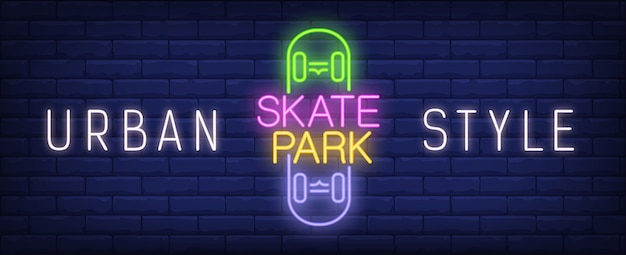 Insegna al neon dello skate park di stile urbano. iscrizione colorato su skateboard sul muro di mattoni scuro.
