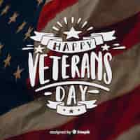 Free vector veterans day lettering with ribbons