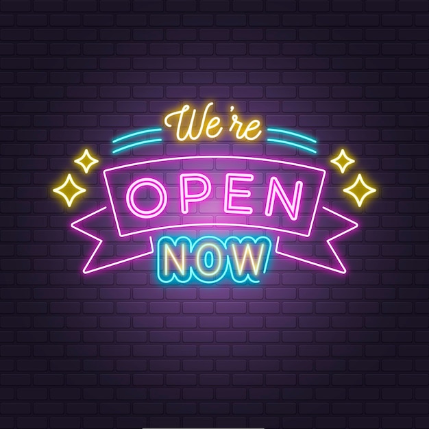 'we are open' neon sign on brick wall