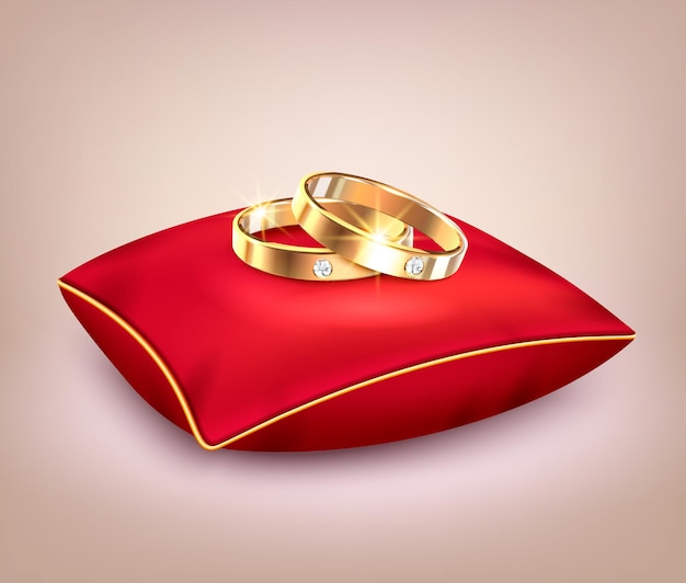 Обручальные золотые кольца с бриллиантами на красной церемониальной подушке