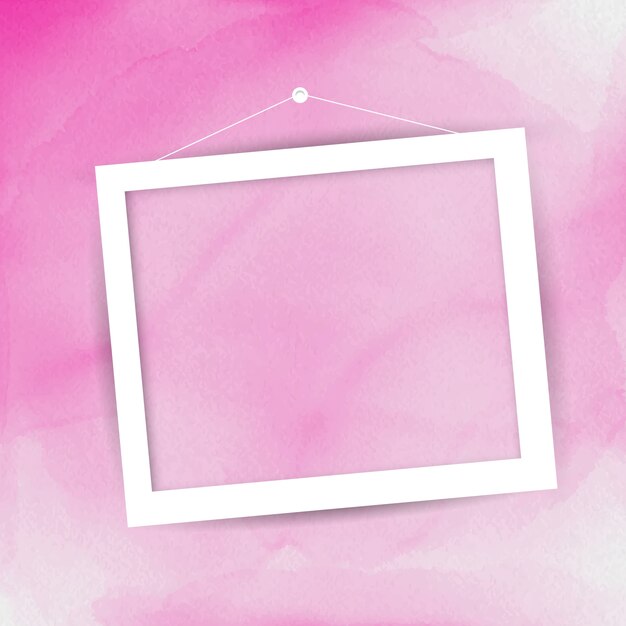 ピンクの水彩画の背景に掛かって空白の額縁