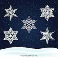 Free vector white snowflakes on a dark background