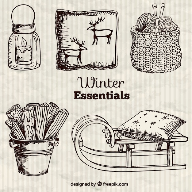 Free vector winter essentials in hand drawn style