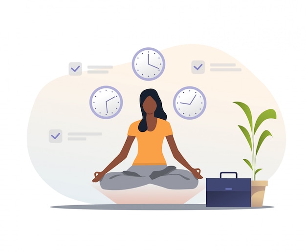 Woman in yoga apparel meditating at workplace
