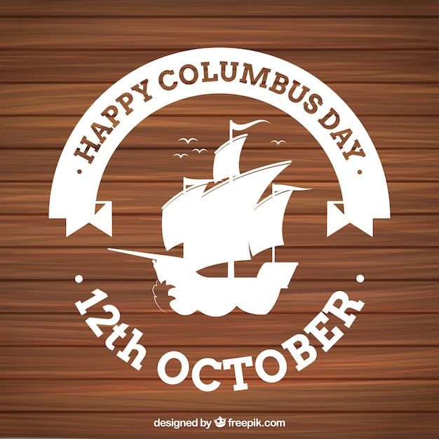 Free vector wooden background with columbus day badge