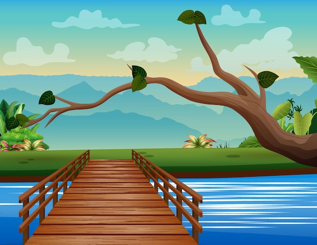 川​の​風景​の​背景​に​架かる​木製​の​橋