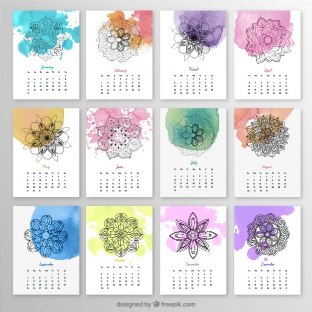 Free vector yearly calendar with mandalas and watercolor splashes