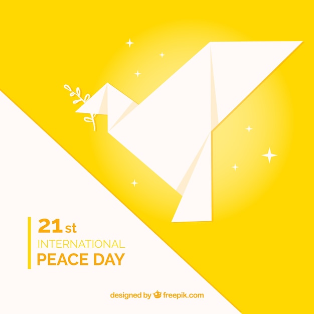 折り紙の鳩と黄色の平和の日の背景