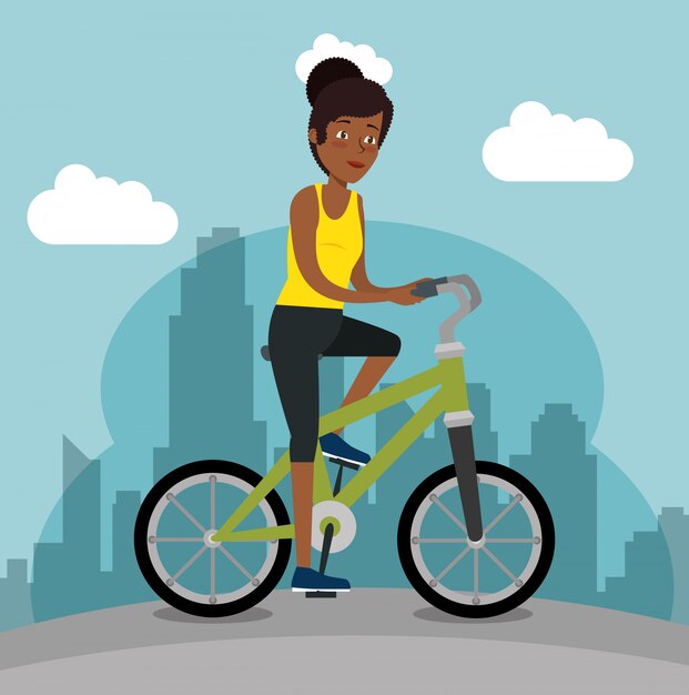 Young black woman riding bicycle